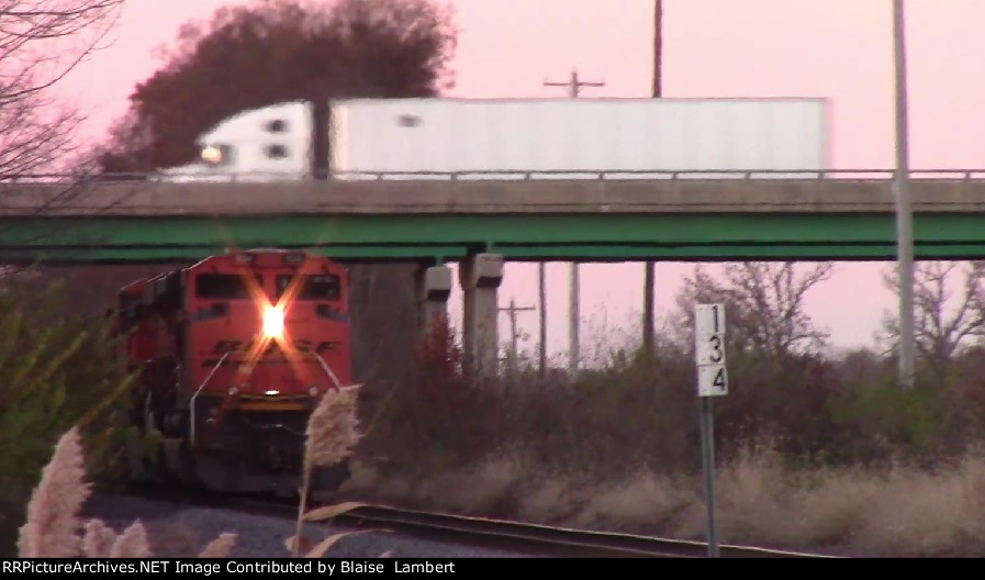 Semi passes over BNSF train